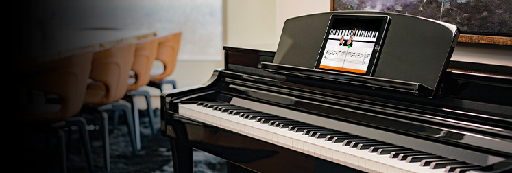 Yamaha Clavinova CSP-150 digital piano with ebony polish, showcasing integrated sheet music display in modern setting.