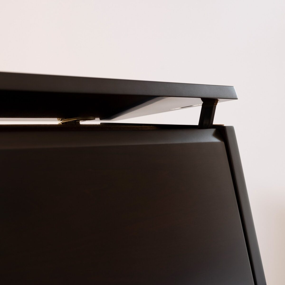 Close-up of a piano lid in ebony finish, detail highlighting premium craftsmanship at Las Vegas Pianos.