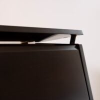 Close-up of a piano lid in ebony finish, detail highlighting premium craftsmanship at Las Vegas Pianos.