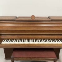 Alt text: Mason & Hamlin upright piano with polished mahogany finish and detailed cabinetry, perfect for any music lover.