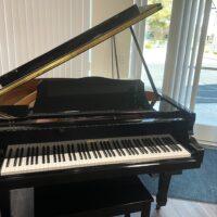 Alt text: Hobart M. Cable grand piano with polished ebony finish and open lid, showcasing premium craftsmanship at Las Vegas Pianos.